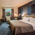 Hennessy Park Hotel in Ebene guest room with king bed, window view, and seating area