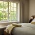 Hotel Belvedere in Kingston guest room with large window, bed, and soft natural light