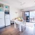 Onslow Beach Resort Onslow apartment dining area with kitchen, balcony, and ocean view