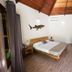 Blue World Dharavandhoo room with wooden bed, daybed and high wood ceiling in Dharavandhoo
