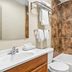 Days Inn by Wyndham Jacksonville NC bathroom with tub-shower combo, sink, mirror, and towel rack