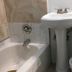Diamond View Motel, Susanville: compact bathroom with pedestal sink, bathtub and toilet