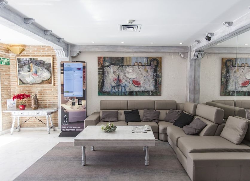 Hotel Pintor El Greco in Toledo lounge with sectional seating, coffee table and modern wall art