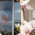 Hotel Ackermann in Riedstadt entrance with glass door, logo, and pink flowers in front