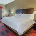 Holiday Inn Express & Suites Bowling Green hotel room with king bed, desk, and window seating
