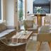 Parkhotel Oberhausen lobby with sofas, armchairs, coffee table and dining nook in Oberhausen
