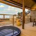 Ooedo Onsen Monogatari Wanwan Resort Yataya Shotoen in Kaga: open-air bath on wooden terrace with scenic view