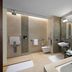 JW Marriott Hotel Bengaluru bathroom with soaking tub, dual sinks, wall-mounted toilet and walk-in shower
