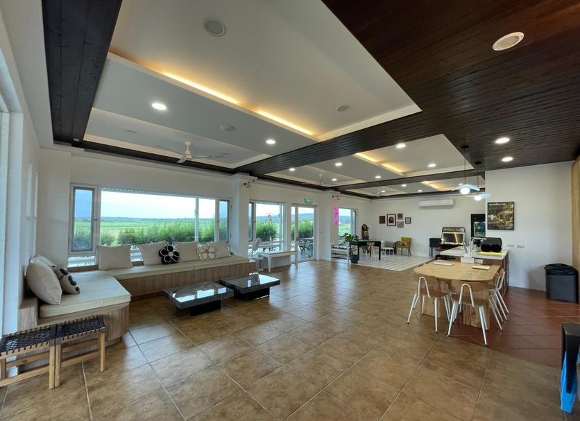 The Jungle House, Hengchun Township: spacious lounge with large windows and distant green views