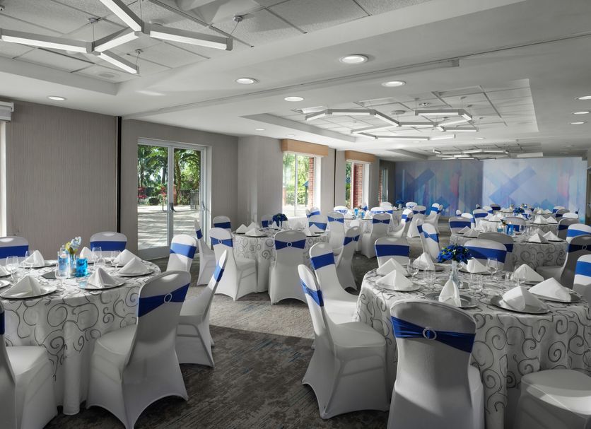 Hilton Garden Inn Tampa-East/Brandon in Tampa banquet room set with round tables and blue chair sashes