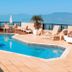 Hotel Jangada Flat in Caraguatatuba with rooftop pool, lounge chairs and ocean views