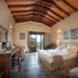 Castello Antico Hotel in Gytheio guest room with wood-beamed ceiling and sea view balcony