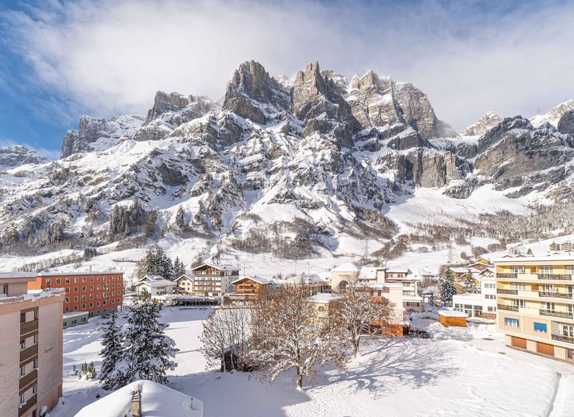 Grichting Hotel & Serviced Apartments in Leukerbad with snowy mountain views and village buildings
