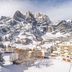 Grichting Hotel & Serviced Apartments in Leukerbad with snowy mountain views and village buildings