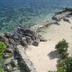 Iris Island Eco Resort in Busuanga with rocky shoreline and clear turquoise ocean view