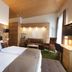 Waldhotel am Notschreipass guest room in Todtnau with twin beds, sofa, desk and plaid chairs
