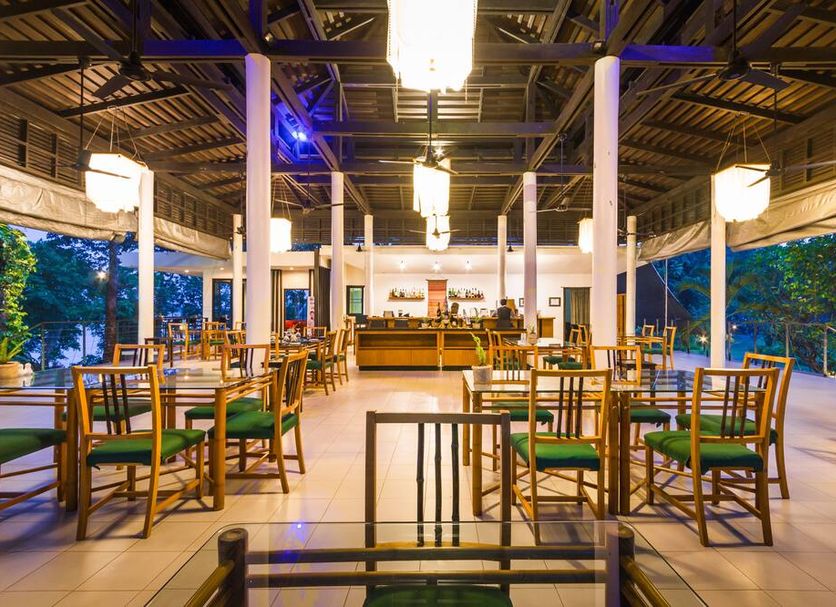 The River Resort in Champasak open-air riverside restaurant with wooden tables and chairs