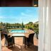 Hilton Garden Inn Venice Mestre San Giuliano terrace with table, chairs, and pool view in Venice