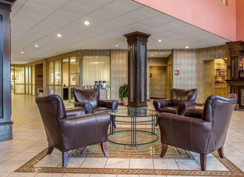 Lobby seating area at Quality Hotel Conference Center Cincinnati Blue Ash in Cincinnati with leather chairs and glass table