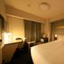 Richmond Hotel Tokyo Suidobashi guest room with double bed, desk, and window curtains in Tokyo