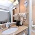 Wingate by Wyndham Beaver I-15 bathroom with vanity, sink, toilet, and wall-mounted hair dryer in Beaver