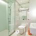 60 West Hotel Hong Kong bathroom with glass shower, wall-mounted toilet and compact sink