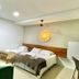 Hospedagem Central in Tiradentes guest room with two beds, green chairs, and ceiling fan