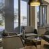 Courtyard by Marriott San Mateo Foster City lobby seating area with large windows and lounge chairs