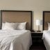 Days Inn & Suites by Wyndham Lexington guest room with two double beds and bedside lamp