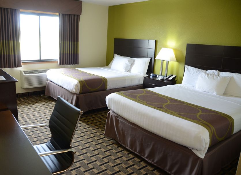 AmericInn by Wyndham West Burlington guest room with two beds, window and desk