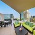 Hilton Dubai The Walk rooftop terrace with seating and panoramic Dubai skyline views