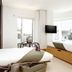 Wilde Aparthotels London Covent Garden room with king bed, wall-mounted TV and city-view windows in London