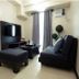 Home Edge Accommodations @ Tivoli Garden Residences Manila living area with sofa, ottoman and TV