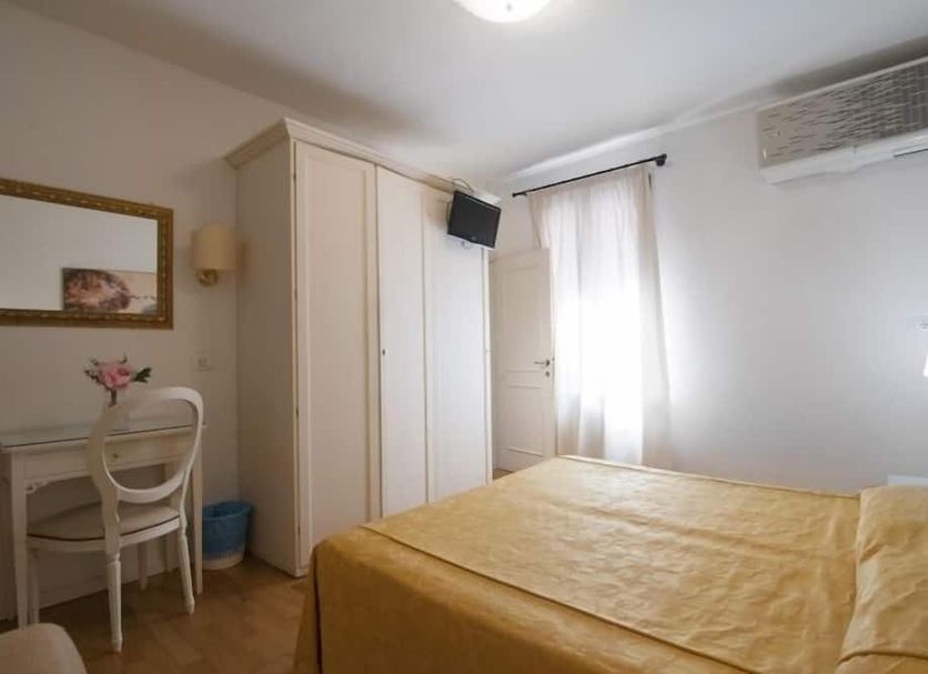 Albergo ai Tolentini in Venice room with bed, desk, wardrobe, window, and wall-mounted air conditioner