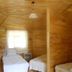 Fire pansiyon in Cirali guest room with three single beds and wood-paneled walls
