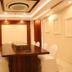 Hotel Tridev Varanasi conference room with long wooden table and white-covered chairs
