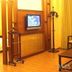 Wealth Shenzhen guest room with wall-mounted TV, wooden paneling, and coat rack