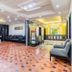 Hotel NavaRATNA lobby in Coimbatore with tiled floor, seating area and reception desk