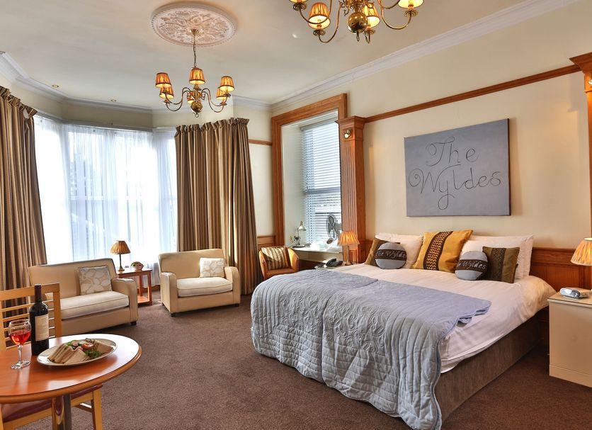 Woodlands Hotel, BW Signature Collection, Dundee guest room with king bed, sofa, armchairs and bay window