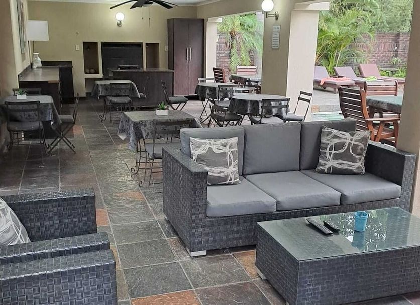 Royal Game Guest House in Phalaborwa with a covered patio, seating area, bar counter and poolside loungers