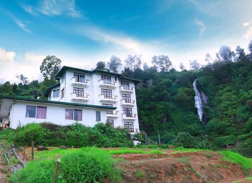 Ashley Resort in Nuwara Eliya beside lush hills and a waterfall