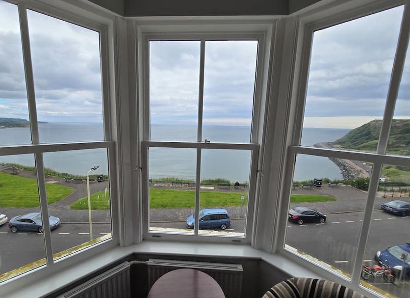 Delmont Hotel in Scarborough bay view through large bay windows overlooking the coast and road