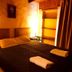 Hosteria La Raclette in San Martín de los Andes, cozy guest room with bed, lamp and shelving