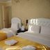 Lotus Hotel Istanbul guest room with two twin beds and yellow bed runners