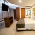 Bristol Umarizal Belem guest room in Belém with double bed, TV, desk and wall art