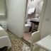 Hostal Mellizo in Lebrija guest room with single bed, curtain-covered window, and compact private bathroom