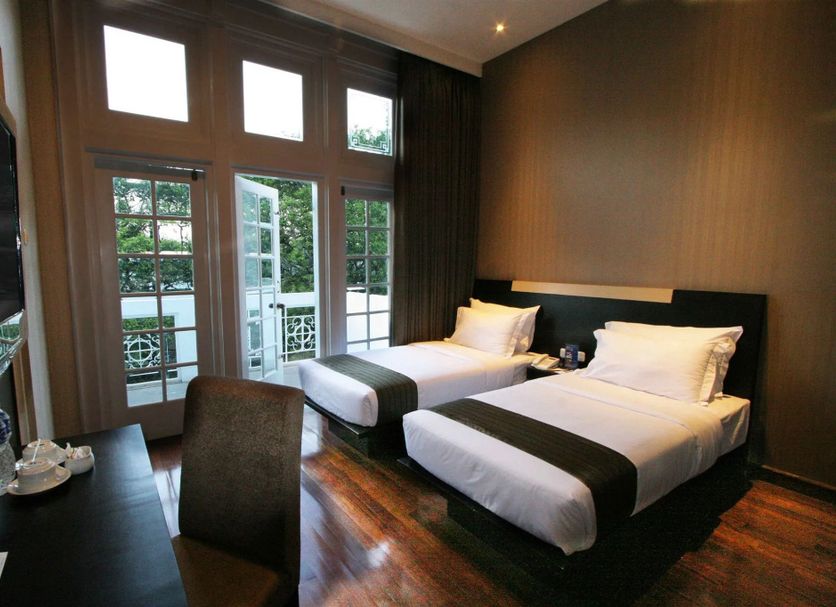 Vio Hotel Cimanuk Bandung room with two twin beds and French doors opening to a balcony in Bandung