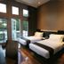 Vio Hotel Cimanuk Bandung room with two twin beds and French doors opening to a balcony in Bandung