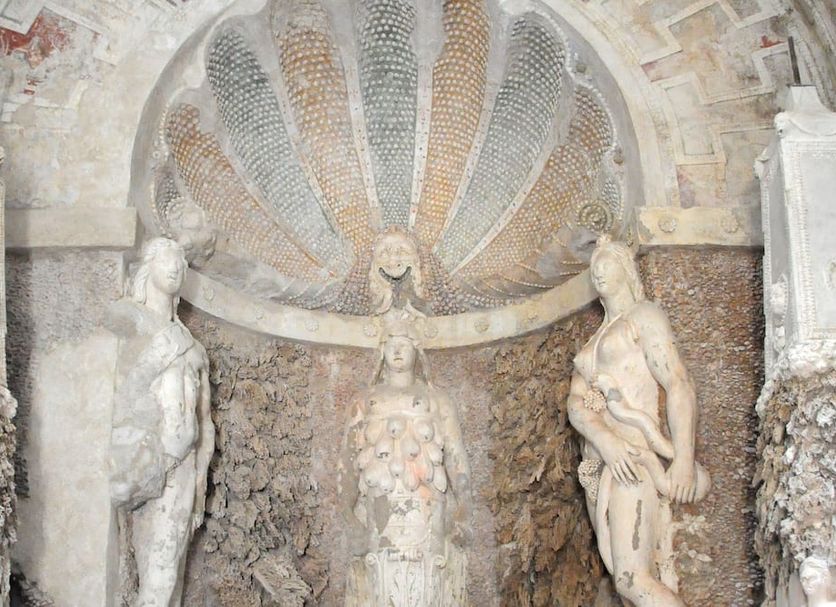 Hotel Athena in Spoleto, stone shell grotto with central female statue and two side figures