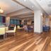 Hampton Inn by Hilton Norwich lobby lounge with wood-look flooring and seating area